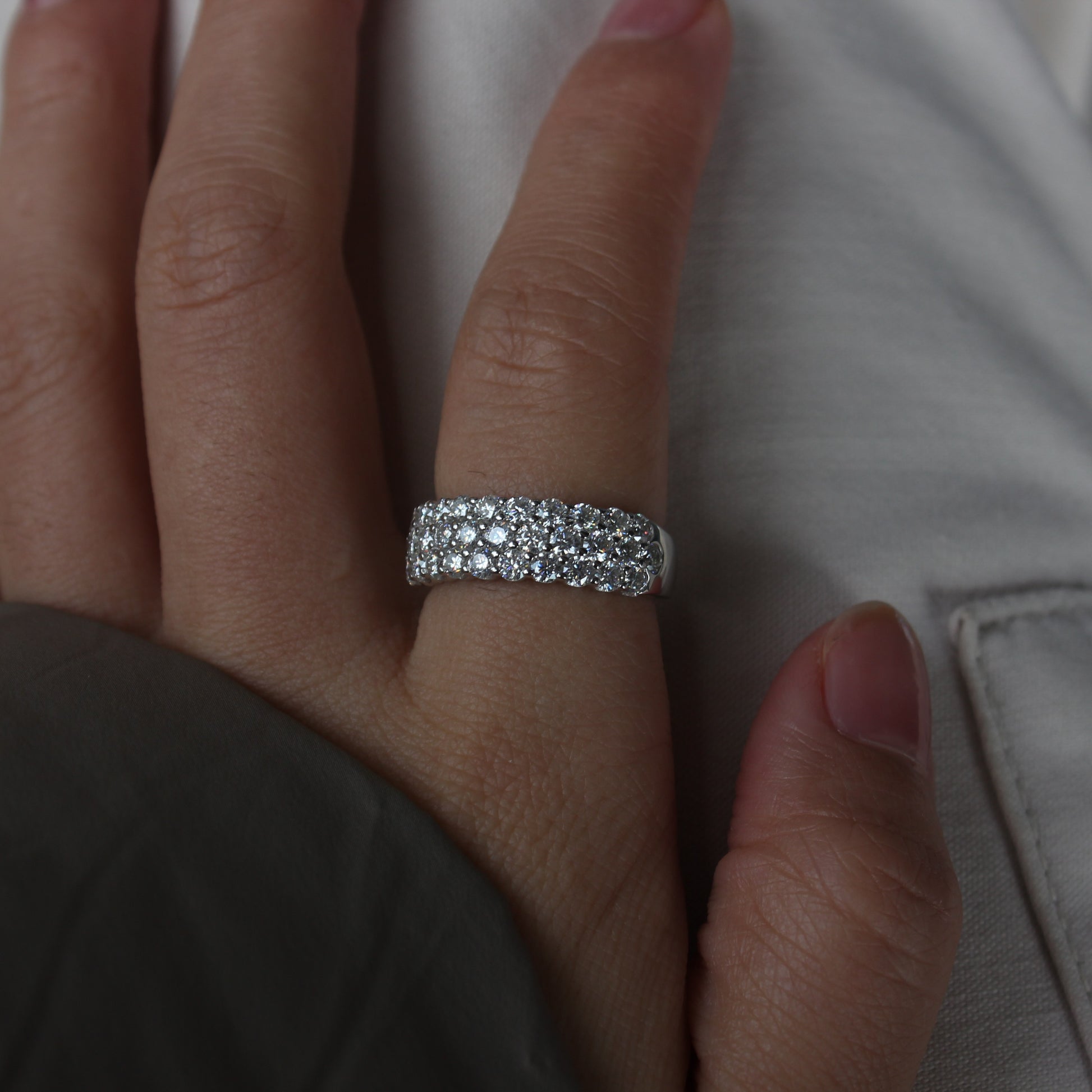 Luna pavé wide moissanite band ring in white gold tone worn on hand, bold minimalist style