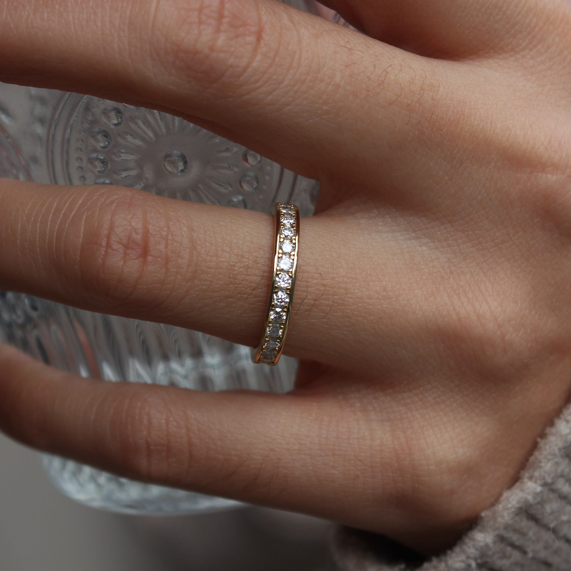 Close view of moissanite eternity band on hand