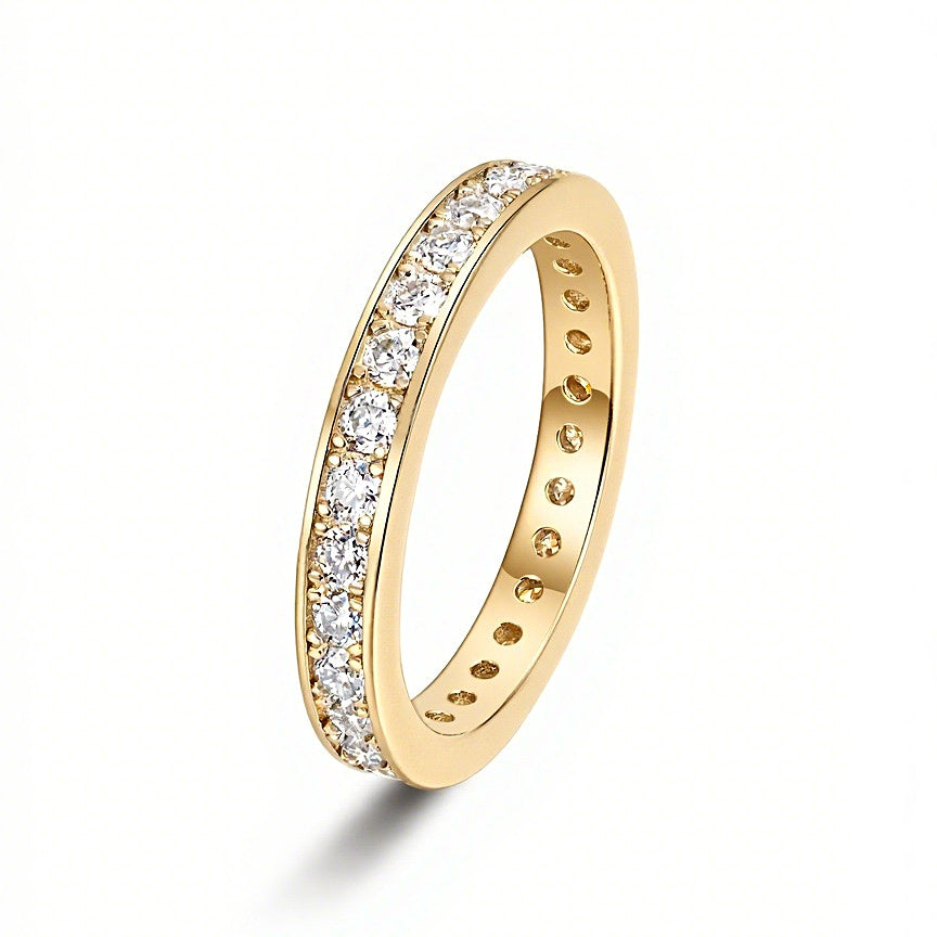 Angled view of moissanite eternity band on white background
