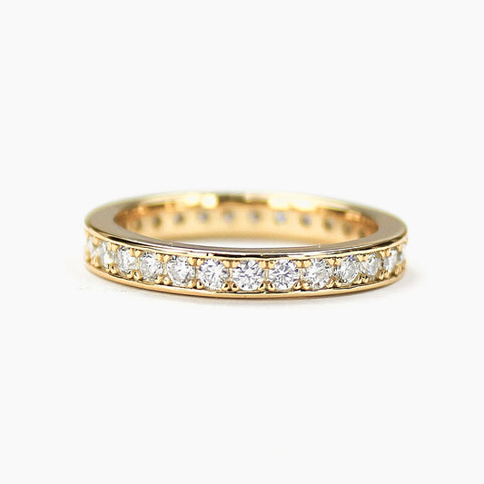 Moissanite eternity band in 18K gold plated sterling silver on white background