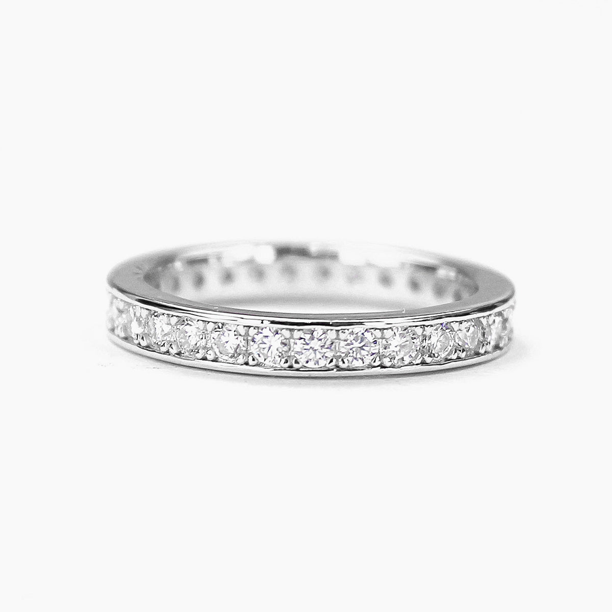 Moissanite eternity band in sterling silver finish on white background