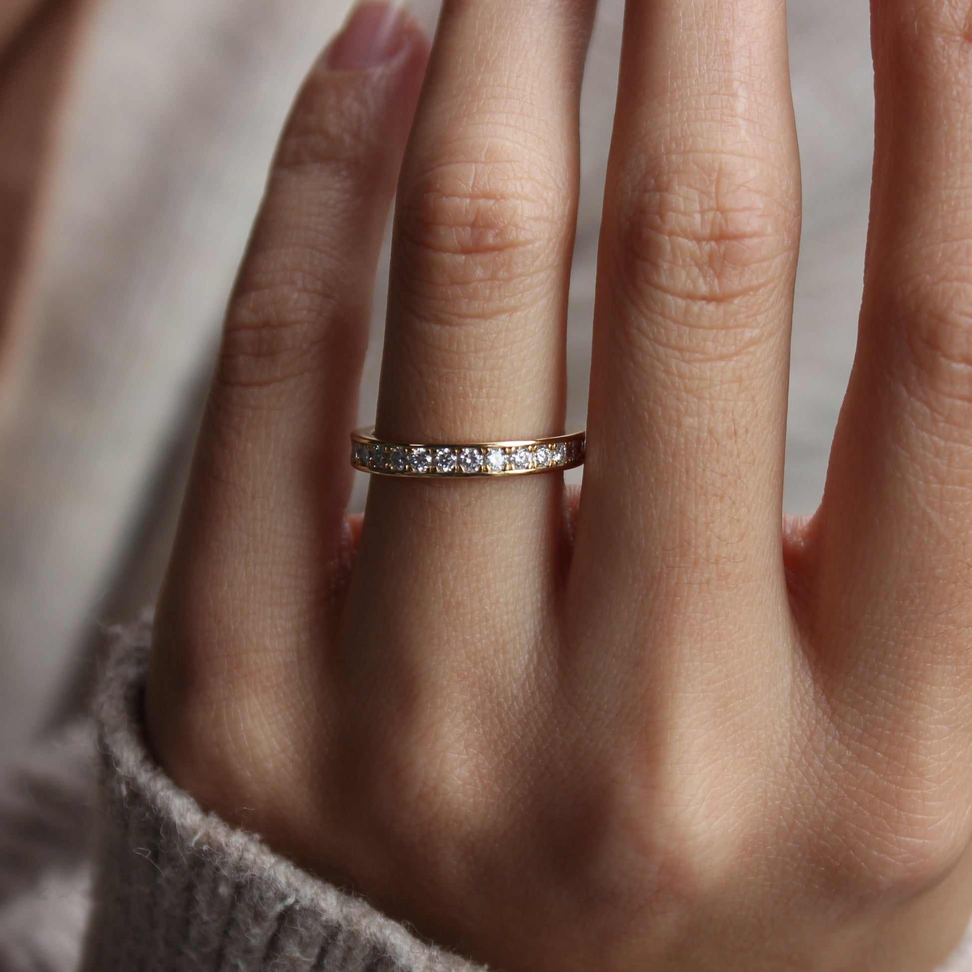 Moissanite eternity band shown on finger