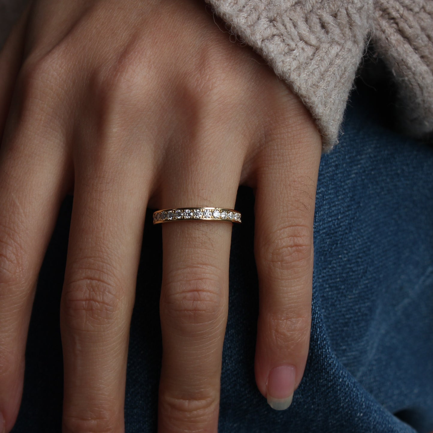 Moissanite eternity band worn in casual hand pose