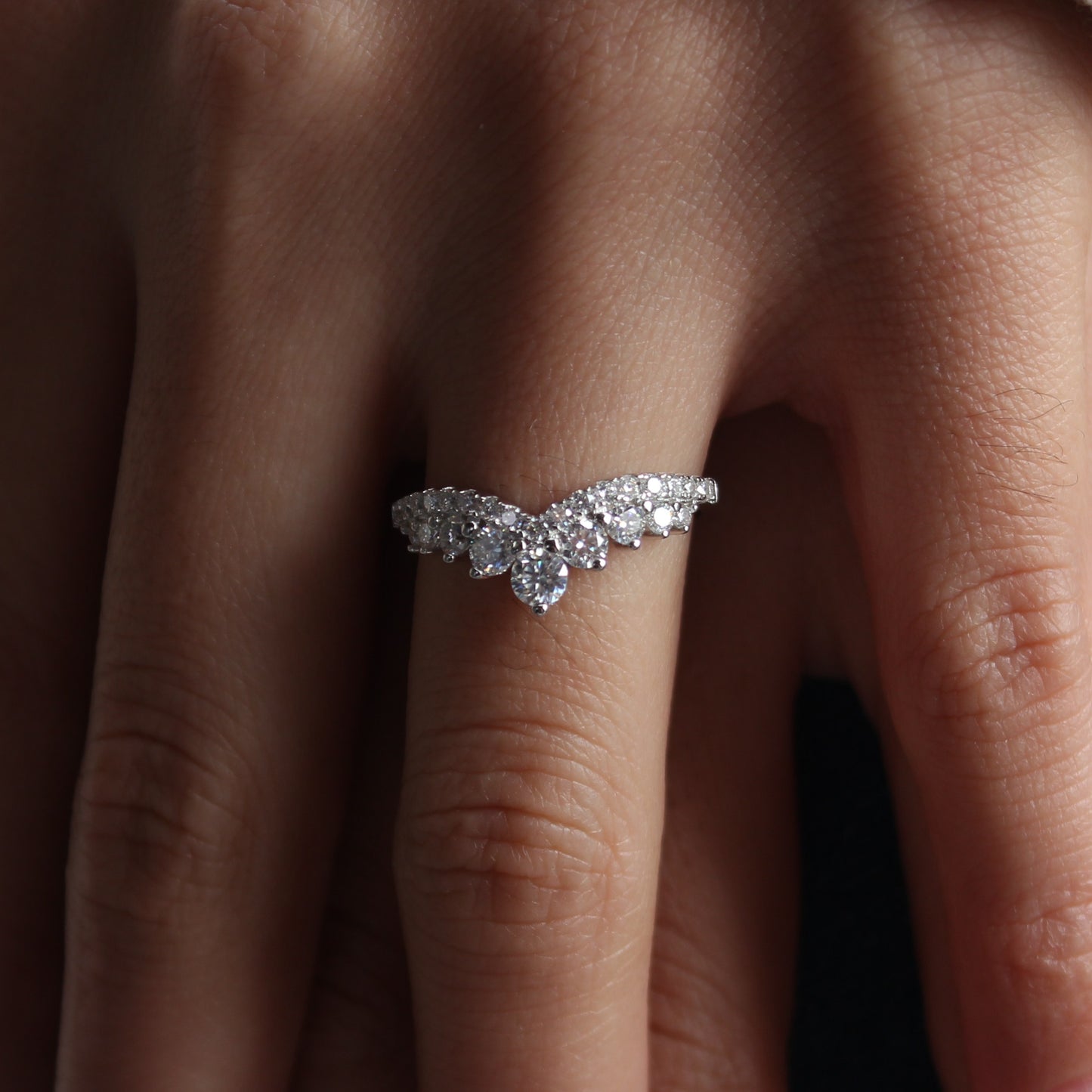 Moissanite pavé curved band shown on hand in natural light