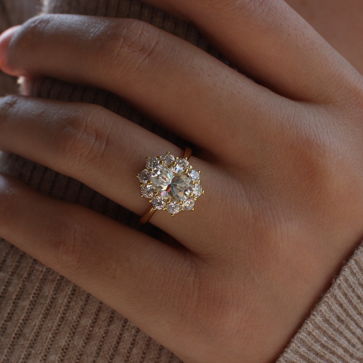 Oval cut halo moissanite ring close-up on hand