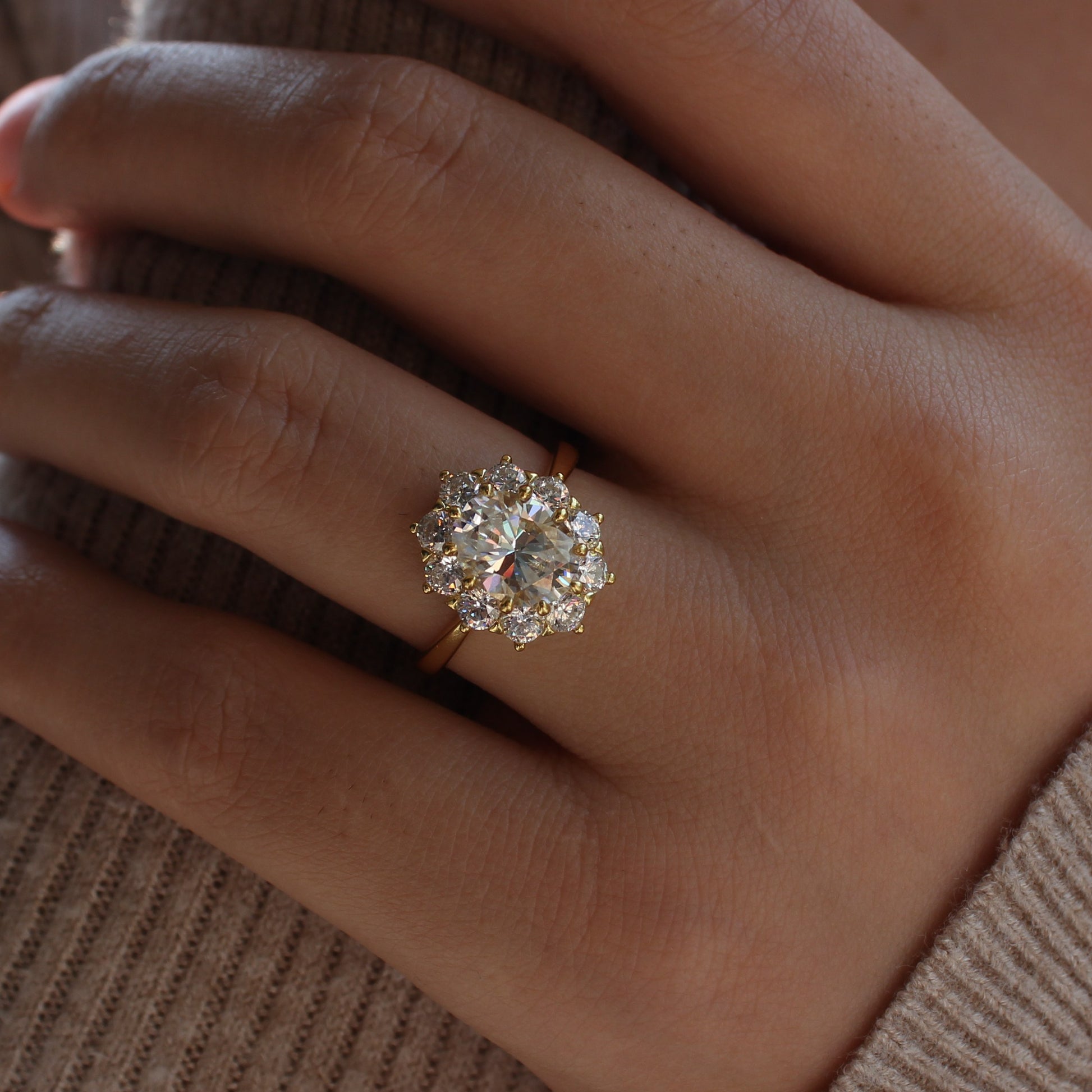 Oval cut halo moissanite ring close-up on hand