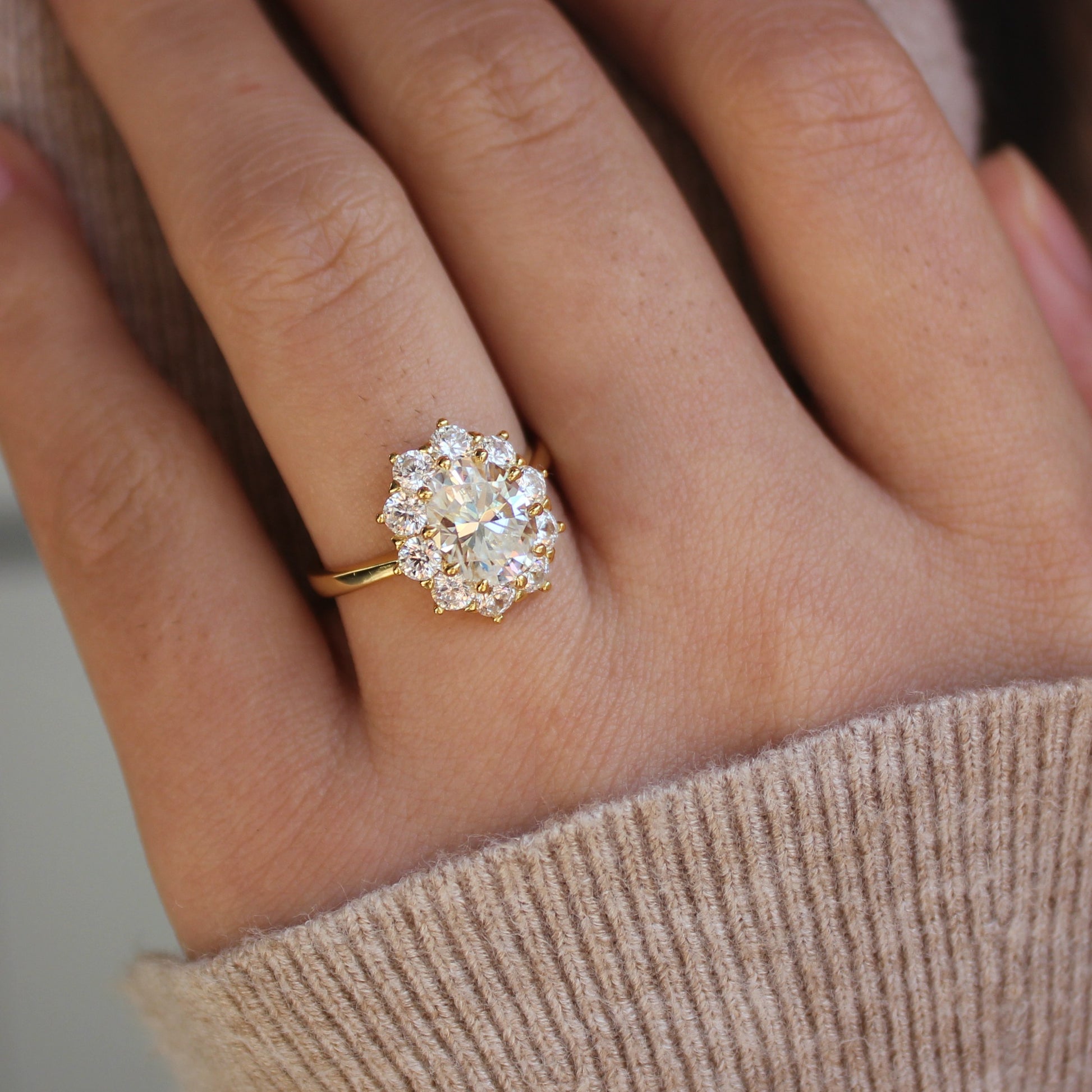 Oval halo moissanite ring worn on hand, gold plated sterling silver