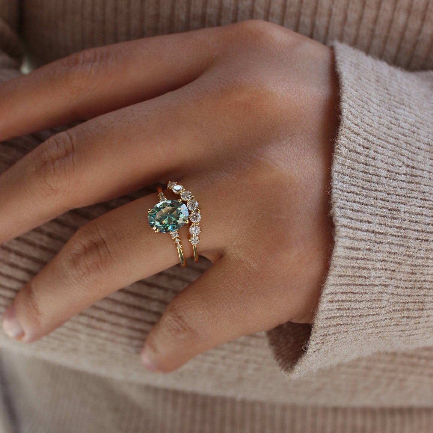 Oval moissanite stackable rings shown on hand with natural light