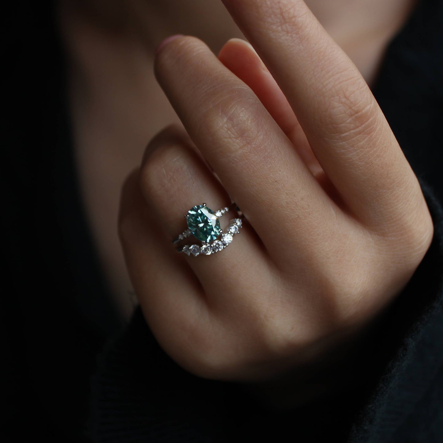 Detailed view of oval moissanite ring set sparkle while worn