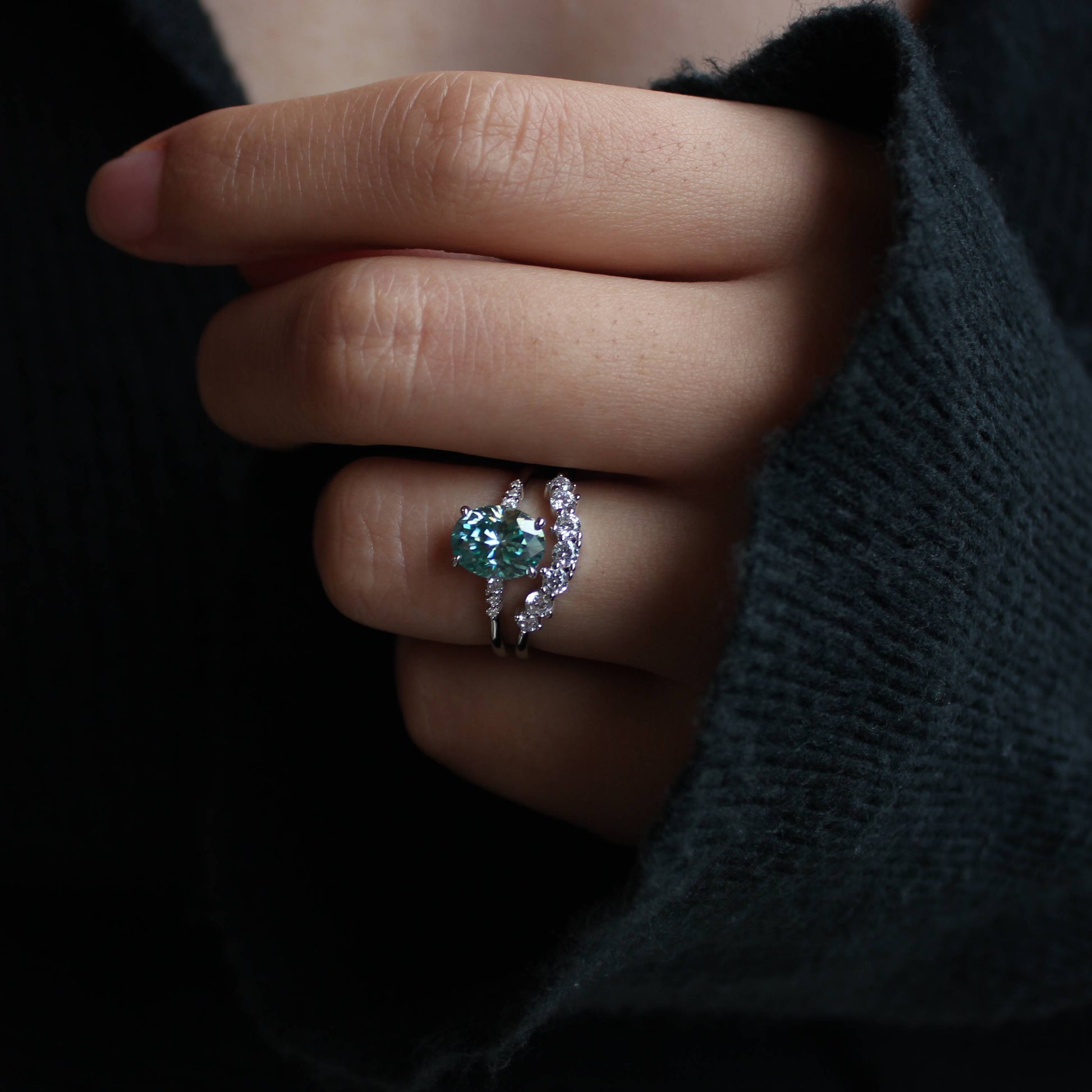 Elegant close-up of oval moissanite ring set worn on finger