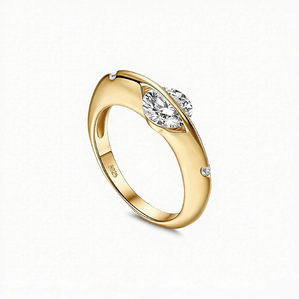 Stellar rotatable moissanite ring in gold tone, vertical angled view on white background