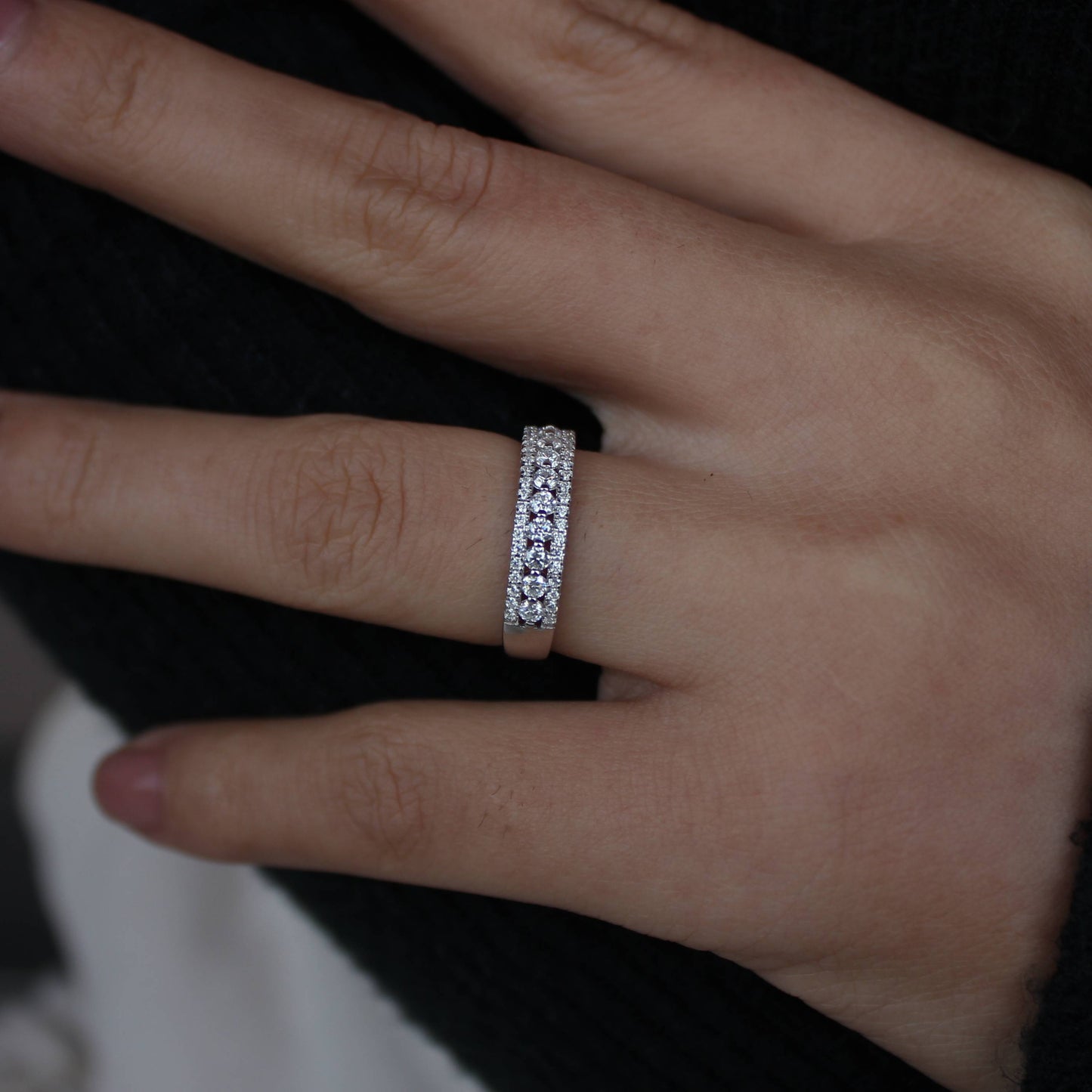 Minimal styling showcasing triple pavé moissanite band ring on hand