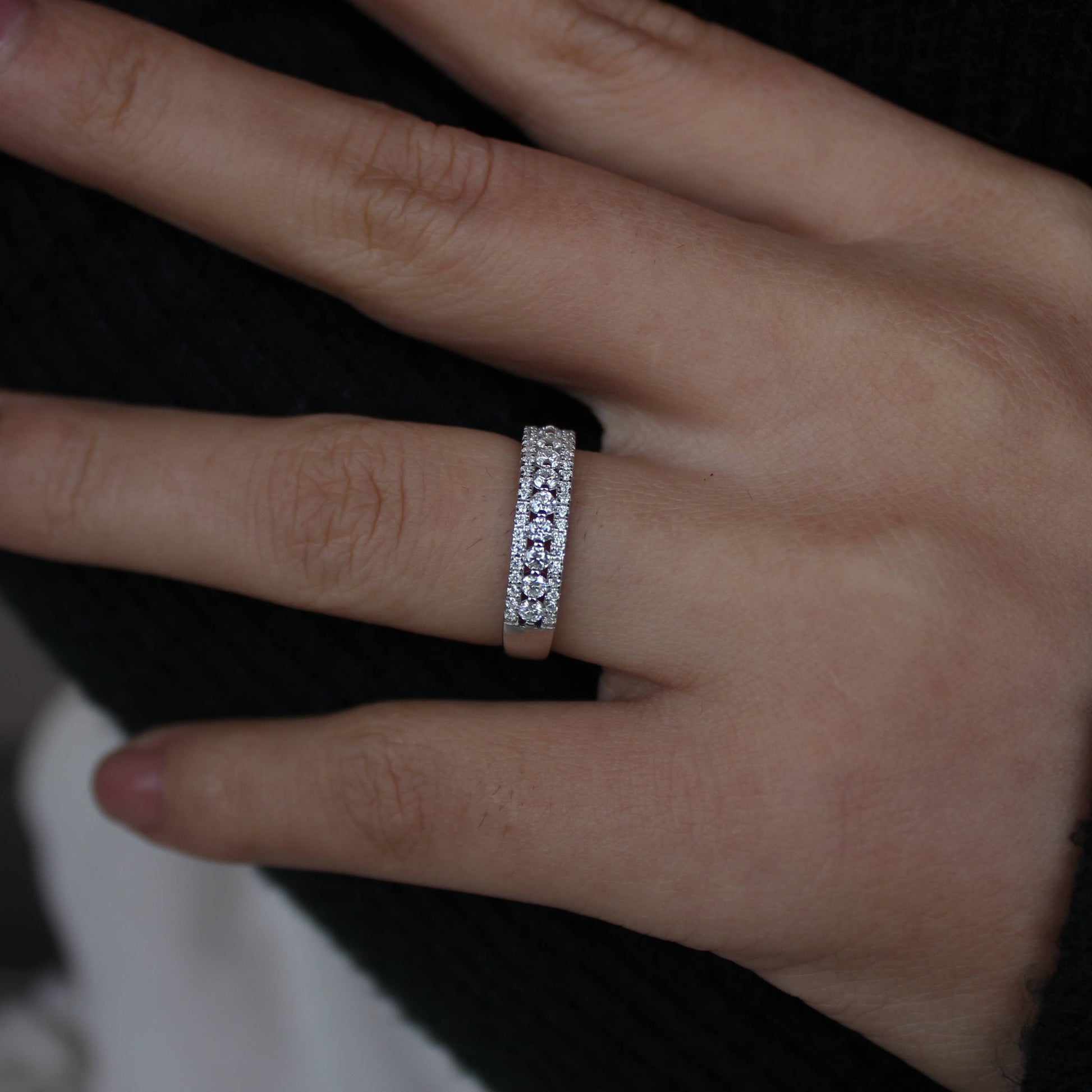 Minimal styling showcasing triple pavé moissanite band ring on hand