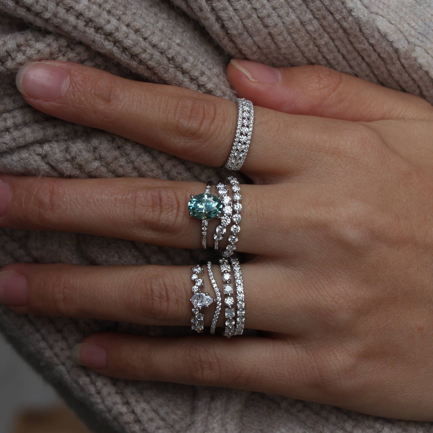 Triple pavé moissanite statement band styled with other rings for stacking look